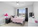 Cozy bedroom featuring carpet, a ceiling fan, large window, and closet at 15444 Old Pond Cir, Noblesville, IN 46060