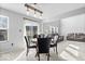 Dining area with modern lighting and a view of the living room at 15444 Old Pond Cir, Noblesville, IN 46060