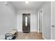 Entryway with a decorative front door, tile flooring, and a bench for shoe storage at 15444 Old Pond Cir, Noblesville, IN 46060