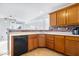 Cozy kitchen with wood cabinets, brick backsplash, modern appliances and views to an open living area at 15444 Old Pond Cir, Noblesville, IN 46060