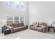 Bright living room with high ceilings, plush carpeting, and comfortable seating at 15444 Old Pond Cir, Noblesville, IN 46060