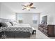 Bright main bedroom with carpeting, a ceiling fan, and a large dresser at 15444 Old Pond Cir, Noblesville, IN 46060
