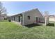 A neat backyard featuring a grassy lawn and a patio area with outdoor seating at 1739 Wellesley Commons # 48A, Indianapolis, IN 46219