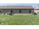 A green backyard featuring a well-maintained lawn and the home's exterior at 1739 Wellesley Commons # 48A, Indianapolis, IN 46219