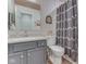 Bathroom featuring a gray vanity with a white countertop and a shower with patterned curtains at 1739 Wellesley Commons # 48A, Indianapolis, IN 46219