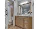 Bright bathroom featuring a barn-door style mirror and a view of the toilet and shower at 1739 Wellesley Commons # 48A, Indianapolis, IN 46219