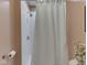 Bright bathroom features a shower behind a white curtain at 1739 Wellesley Commons # 48A, Indianapolis, IN 46219