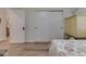 A bedroom featuring wood-look floors, a comfortable bed, and ample closet space at 1739 Wellesley Commons # 48A, Indianapolis, IN 46219