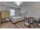 A cozy bedroom with wood floors, a metal bed frame, and a desk area at 1739 Wellesley Commons # 48A, Indianapolis, IN 46219