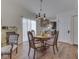 Cozy dining area with wood floors, a chandelier, and a kitchen view, perfect for Gathering meals at 1739 Wellesley Commons # 48A, Indianapolis, IN 46219