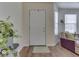 Bright entryway featuring hardwood floors, a white front door, and a view of the living area at 1739 Wellesley Commons # 48A, Indianapolis, IN 46219