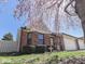 Charming brick home featuring an attached two-car garage, a well-manicured lawn, and a lovely flower bed at 1739 Wellesley Commons # 48A, Indianapolis, IN 46219