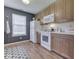 Modern kitchen featuring wood cabinets, contrasting wall color, and stainless steel appliances at 1739 Wellesley Commons # 48A, Indianapolis, IN 46219