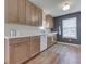 Modern kitchen featuring wood cabinets, contrasting wall color, and stainless steel appliances at 1739 Wellesley Commons # 48A, Indianapolis, IN 46219