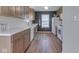 Well-lit kitchen with neutral tones, sleek countertops, and a stylish star-patterned rug at 1739 Wellesley Commons # 48A, Indianapolis, IN 46219