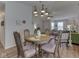 Open-concept living space with a dining area that connects to a brightly lit sitting room at 1739 Wellesley Commons # 48A, Indianapolis, IN 46219