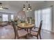 Inviting open-concept living room with hardwood floors, seamlessly blending dining and relaxation areas at 1739 Wellesley Commons # 48A, Indianapolis, IN 46219