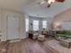 Cozy living room featuring hardwood floors, a ceiling fan, and comfortable seating at 1739 Wellesley Commons # 48A, Indianapolis, IN 46219