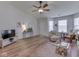 Bright living room featuring hardwood floors, a ceiling fan, and comfortable seating at 1739 Wellesley Commons # 48A, Indianapolis, IN 46219