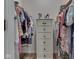 A well-organized walk-in closet with a central chest of drawers and clothes hanging on both sides at 1739 Wellesley Commons # 48A, Indianapolis, IN 46219