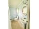 Cozy bathroom with pedestal sink, oval mirror and tiled floors at 1761 Country Lane Dr, Greenfield, IN 46140