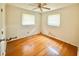 Bedroom featuring hardwood floors, two windows and ceiling fan at 1761 Country Lane Dr, Greenfield, IN 46140
