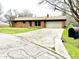 Brick single-story house featuring an attached garage and a spacious front yard at 1761 Country Lane Dr, Greenfield, IN 46140