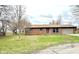 A single-story brick home featuring a well-maintained lawn at 1761 Country Lane Dr, Greenfield, IN 46140