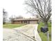 Charming single-story brick home with a two-car garage and long driveway at 1761 Country Lane Dr, Greenfield, IN 46140