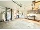 Garage with concrete floor, shelving, storage, and water heater at 1761 Country Lane Dr, Greenfield, IN 46140