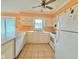 A sunny kitchen with tile floors and traditional white cabinetry and appliances at 1761 Country Lane Dr, Greenfield, IN 46140