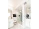 Modern bathroom featuring double sinks, sleek mirrors, and a glass-enclosed shower with unique geometric tile at 1802 Bellefontaine St, Indianapolis, IN 46202