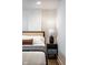 Stylishly designed bedroom with unique headboard and a complementing bedside table lamp at 1802 Bellefontaine St, Indianapolis, IN 46202