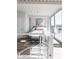 Bright, airy bedroom featuring a large window, stylish bench, and elegant decor at 1802 Bellefontaine St, Indianapolis, IN 46202