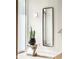 Modern entryway featuring a decorative mirror, plant, and stylish lighting at 1802 Bellefontaine St, Indianapolis, IN 46202