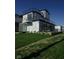 Unique three-story home with a modern design, featuring large windows and a well-maintained lawn at 1802 Bellefontaine St, Indianapolis, IN 46202