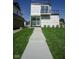 Modern home with sleek lines and lush lawn, showcasing its contemporary design and curb appeal at 1802 Bellefontaine St, Indianapolis, IN 46202