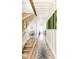 Bright hallway featuring wood floors, statement wall decor, and a modern staircase at 1802 Bellefontaine St, Indianapolis, IN 46202
