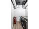Modern laundry room with gray front load washer and dryer and exposed ductwork at 1802 Bellefontaine St, Indianapolis, IN 46202