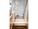 Well-lit wooden stairway accented with a decorative plant, adding a touch of nature at 1802 Bellefontaine St, Indianapolis, IN 46202