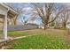 Spacious backyard featuring a large tree, a storage shed, and a fenced-in perimeter at 1911 Wilcox St, Indianapolis, IN 46222