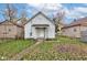 View of the home's backyard showcasing its well-maintained lawn and charming exterior at 1911 Wilcox St, Indianapolis, IN 46222