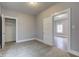 This carpeted bedroom offers a closet and doorway leading into another bedroom at 1911 Wilcox St, Indianapolis, IN 46222