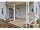 Inviting front porch features classic white columns and wood flooring at 1911 Wilcox St, Indianapolis, IN 46222