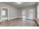 Bright living room with wood floors and multiple doorways for easy access at 1911 Wilcox St, Indianapolis, IN 46222