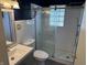 Bathroom featuring a glass shower with a tiled wall, sleek vanity, and a tiled floor at 1952 N Colorado Ave, Indianapolis, IN 46218