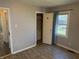 Bedroom featuring a window, closet, and grey walls, complete with modern wood-look floors at 1952 N Colorado Ave, Indianapolis, IN 46218