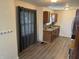 Spacious kitchen with warm cabinets, stainless steel appliances, and gray vinyl plank flooring at 1952 N Colorado Ave, Indianapolis, IN 46218