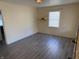 An empty living room featuring neutral colored walls and modern gray vinyl plank floors at 1952 N Colorado Ave, Indianapolis, IN 46218