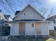Rear exterior view of a two-story home with light gray siding showing covered back entrances at 2148 Singleton St, Indianapolis, IN 46203